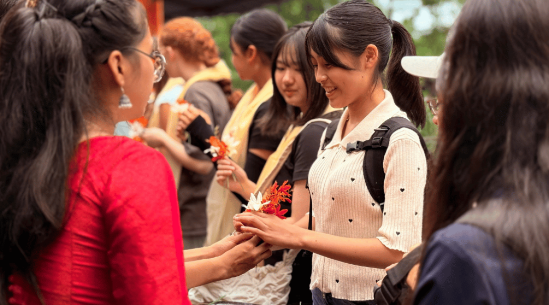 A young person holding a flower